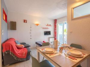a living room with a table and a dining room at Apartment Bleu Marine by Interhome in Saint-Georges-de-Didonne