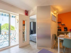 a room with a kitchen and a dining room with a table at Apartment Bleu Marine by Interhome in Saint-Georges-de-Didonne