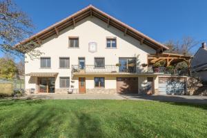 an exterior view of a house with a garage at Vacances La Montagne in Saint-Julien-en-Champsaur