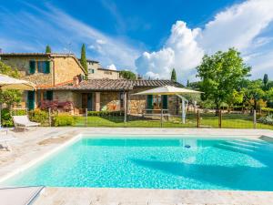 a villa with a swimming pool in front of a house at Holiday Home Casa 360 by Interhome in Greve in Chianti
