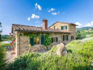 a stone house with green shutters on a hill at Holiday Home Casa 360 by Interhome in Greve in Chianti