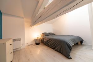 a bedroom with a bed and a large window at KASA DUPLEX - Climatisation - Balcon - Parking Privé in Rive-de-Gier