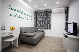 a living room with a couch and a television at Apartment 4 You in Split in Split