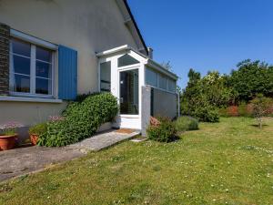 a house with a white door and a yard at Holiday Home Le Colibri by Interhome in Cabourg