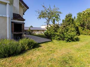 a yard next to a house with trees and grass at Holiday Home Le Colibri by Interhome in Cabourg