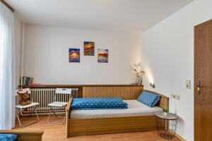 a bedroom with a bed with blue pillows at Heidi Kimmig in Bad Griesbach