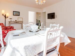 une salle à manger avec une table et des chaises blanches dans l'établissement Holiday Home Le Colibri by Interhome, à Cabourg 11 autres photos