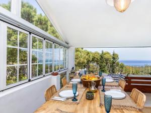 a dining room with a table and some windows at Holiday Home Casa Blue Art by Interhome in Pals
