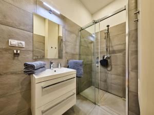 y baño con lavabo y ducha acristalada. en Apartment Portášky- Velká Úpa 2 by Interhome, en Pec pod Sněžkou