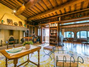 a living room with a table and a fireplace at Holiday Home Lamore di Carla by Interhome in Greve in Chianti