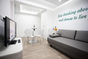 a living room with a couch and a tv and a table at Apartment 4 You in Split in Split