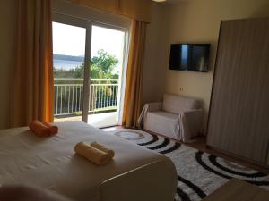 a bedroom with a bed and a large window at Apartments & Rooms Marina in Dramalj
