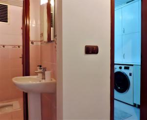 a bathroom with a sink and a washing machine at Central and Serene Flat with Balcony in Antalya in Antalya