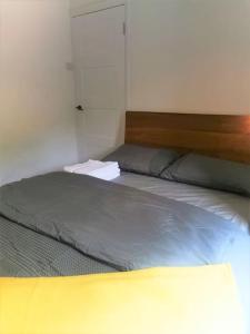 a bedroom with a bed with a wooden head board at Newly Renovated 3 bedroom house in Taibach