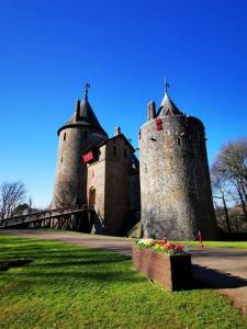 two towers of a castle with a bridge at Newly Renovated 3 bedroom house in Taibach