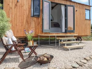 a tiny house with a large screened in porch at Little Pip in Penzance