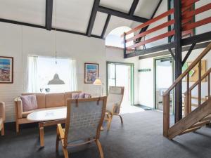 a living room with a couch and a table and chairs at Apartment Labarnas - 800m from the sea in Western Jutland by Interhome in Fanø