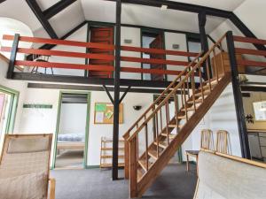 a room with a spiral staircase in a house at Apartment Labarnas - 800m from the sea in Western Jutland by Interhome in Fanø