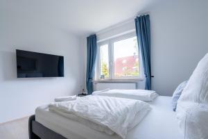 Postel nebo postele na pokoji v ubytování 2 Zimmer Ferienwohnung Am Hafen