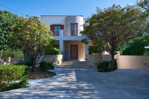 a villa with a driveway leading to a house at Anthemis Luxury Villa in Kalymnos