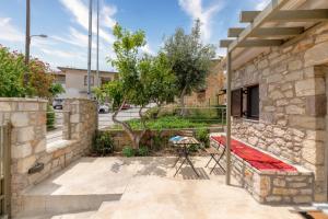 a patio with a table outside of a building at Fotoula's stone studio in Groustésion