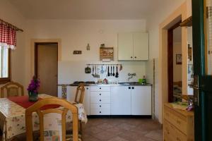 a kitchen with white cabinets and a table and a table and a tableablish at House Petra in Sali