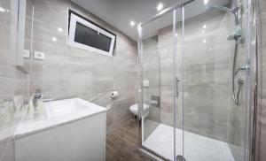 a bathroom with a shower and a sink and a toilet at Apartment 4 You in Split in Split
