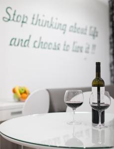 a bottle of wine and two glasses on a table at Apartment 4 You in Split in Split