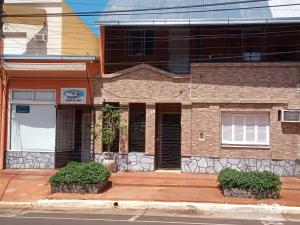 a brick building on the side of a street at La Casa de Sol in Posadas