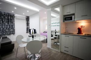 a kitchen and living room with a table and chairs at Apartment 4 You in Split in Split
