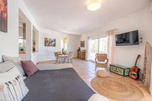 a living room with a couch and a table at Sunset lover Cala Comte/ Cala Tarida/ Cala Bassa in Sant Josep de Sa Talaia
