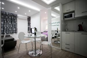 a kitchen and living room with a table and chairs at Apartment 4 You in Split in Split