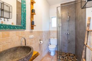 a bathroom with a tub and a toilet and a shower at Sunset SPA Villa Cala Tarida in Sant Josep de sa Talaia