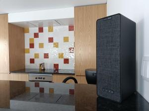 a computer monitor in a kitchen with a counter at Gozo - new luxury villa with private pool in Foz do Arelho
