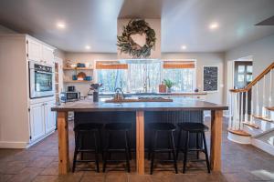 a kitchen with a large island with bar stools at Hot Tub, Firepit, 2 King Beds, Game Room, 200 +mbps in Hawley