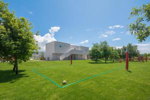 a park with a volley ball court and swings at Maj Luxury Residence in Poreč