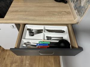 a drawer full of utensils in a wooden box at Carpathian Dream Apartments in Yaremche