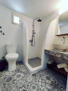 a bathroom with a toilet and a sink at AQUAMARINE APARTMENT in Patitiri