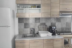 a kitchen with a sink and a counter top at AQUAMARINE APARTMENT in Patitiri