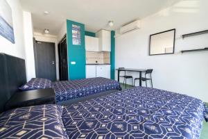 a hotel room with two beds and a table at Coconut Apartments - Adults Only in Magaluf