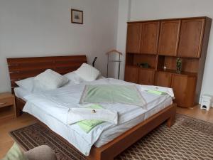 una camera da letto con un letto con lenzuola bianche e asciugamani verdi di PAVLA-ubytování v Poštorné a Břeclav