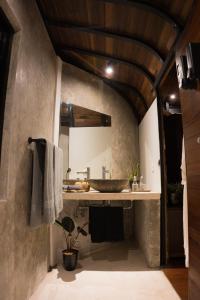 La salle de bains est pourvue d'un lavabo et d'un miroir. dans l'établissement Green Tree House Villa Ubud, à Ubud