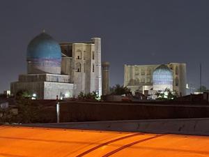 a large building with two domes in front of it at Hanifa Boutique Hotel in Samarkand