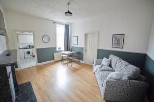 a living room with a couch and a table at Flat in Gateshead in Gateshead