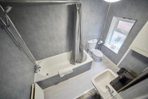a bathroom with a tub and a toilet and a sink at Flat in Gateshead in Gateshead