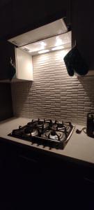 a stove top oven in a kitchen with a light at Brown Aparts in Chişinău