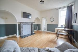 a living room with a fireplace and a table at Flat in Gateshead in Gateshead