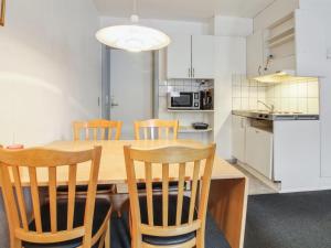 a kitchen and dining room with a wooden table and chairs at Apartment Valli - 22km from the sea in Western Jutland by Interhome in Bredebro
