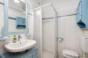 a bathroom with a sink and a toilet and a mirror at Casa Ghibli in Loano +20 photos