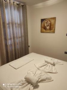 a bedroom with a bed with towels on it at Astradeni luxury apartments Vootis in Páloi